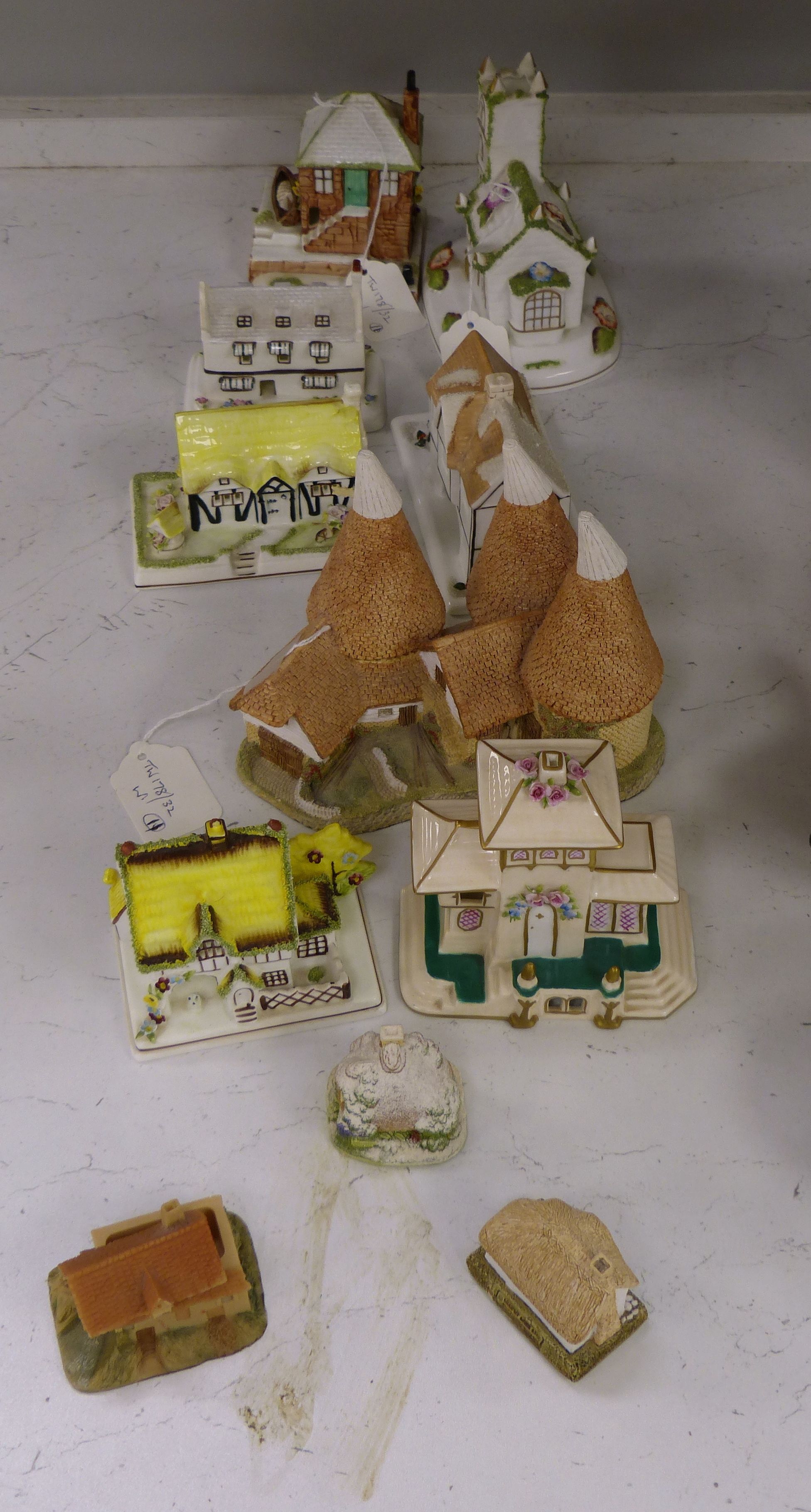 Seven Coalport bone china 'cottage' pastille burners and four similar resin examples (11)